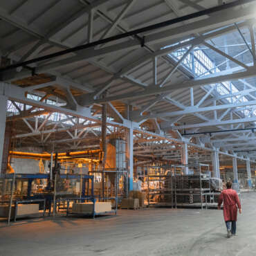 Cement factory interiors. Industrial cement production conveyor. Workers in the shop on the production line